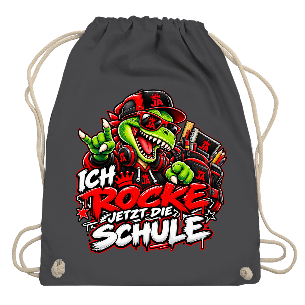JA Schulstart Dino – Turnbeutel in Graphitgrau, Aufdruck: Dino mit Cap und Schulsachen: „Ich rocke jetzt die Schule“ zur Einschulung