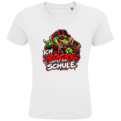 JA Schulstart Dino – Kinder-T-Shirt in Weiß, Vorderansicht, Frontdruck: Dino mit Cap und Schulsachen: „Ich rocke jetzt die Schule“ zur Einschulung