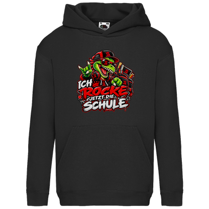 JA Schulstart Dino – Kinder-Hoodie in Schwarz, Vorderansicht, Frontdruck: Dino mit Cap und Schulsachen: „Ich rocke jetzt die Schule“ zur Einschulung