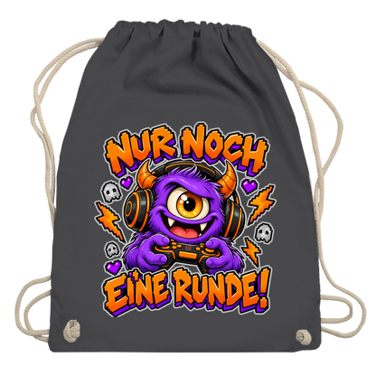 JA Monster Gamer – Turnbeutel in Graphitgrau, Aufdruck: Gaming-Monster mit Controller: „Nur noch eine Runde!“