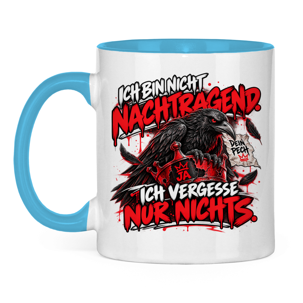 JA Ich vergesse nichts – Tasse in Hellblau, Vorderansicht, Aufdruck: Rabe auf roter Krone: „Ich bin nicht nachtragend. Ich vergesse nur nichts.“
