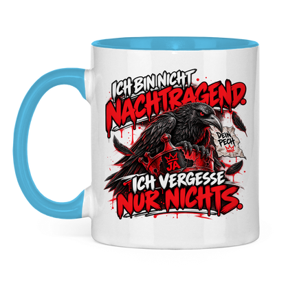 JA Ich vergesse nichts – Tasse in Hellblau, Vorderansicht, Aufdruck: Rabe auf roter Krone: „Ich bin nicht nachtragend. Ich vergesse nur nichts.“