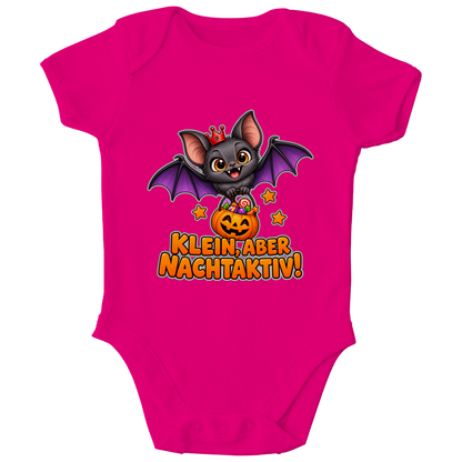 JA Nachtflatterer – Baby-Body in Fuchsia, Vorderansicht, Frontdruck: Kleine Fledermaus mit Kürbiseimer: „Klein, aber nachtaktiv!“