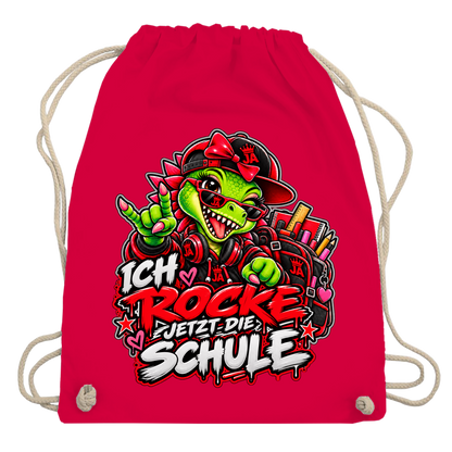 JA Schulstart Dino Mädchen – Turnbeutel in Rot, Aufdruck: Dino-Mädchen mit Schulsachen: „Ich rocke jetzt die Schule“ zur Einschulung
