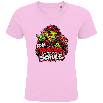 JA Schulstart Dino Mädchen – Kinder-T-Shirt in Zartrosa, Vorderansicht, Frontdruck: Dino-Mädchen mit Schulsachen: „Ich rocke jetzt die Schule“ zur Einschulung