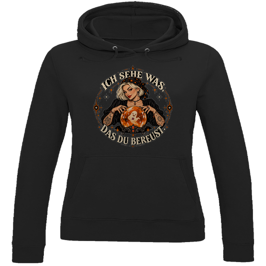 JA Orakel – Damen-Hoodie in Tiefschwarz, Vorderansicht, Frontdruck: Wahrsagerin mit Kristallkugel und Spruch „Ich sehe was, das du bereust“
