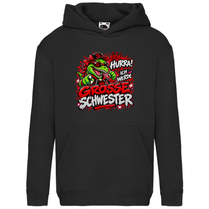 JA Große Schwester Dino – Kinder-Hoodie in Schwarz, Vorderansicht, Frontdruck: Dino-Motiv „Hurra! Ich werde große Schwester“ – Geschenk zur Geschwister-Ankündigung